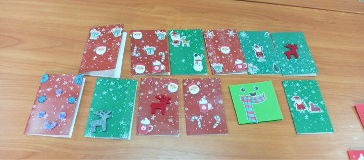 Handmade holiday cards and craft creations displayed on a table after a creative group activity.